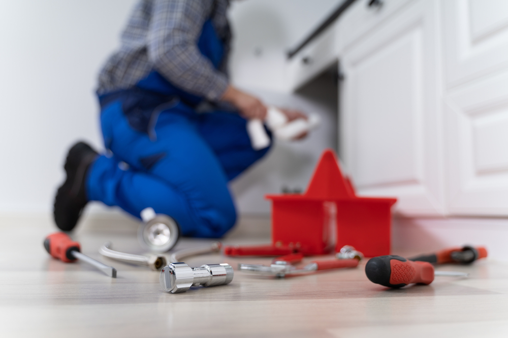 Male,Plumber,In,Overall,Fixing,Kitchen,Sink,Pipe